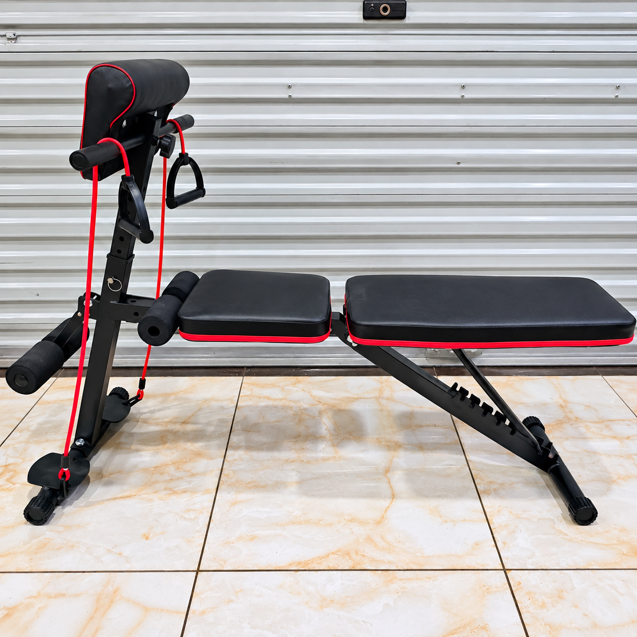 Adjustable workout bench with resistance bands and padded backrest for home gym